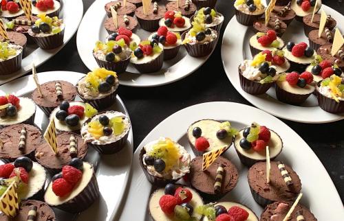 Sharing platters of dark chocolate cups with assorted fillings and toppings.