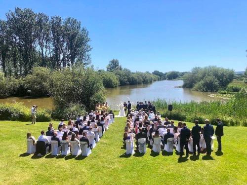 Lakeside wedding ceremony held at Milwards Estate, a wedding venue in Laughton, East Sussex.