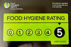Black and green food hygiene rating sticker showing a score of 5