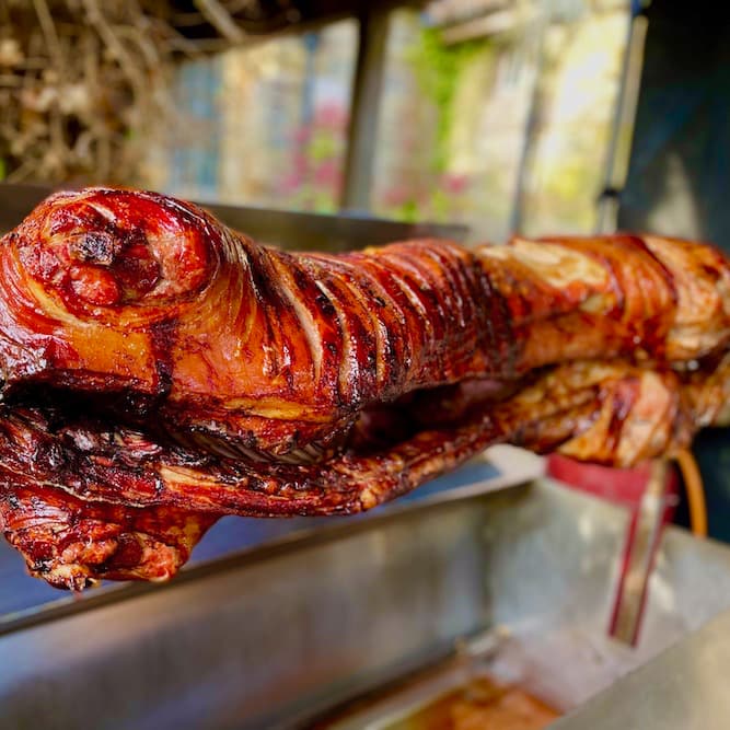 Close up of hog roast with faded out garden background
